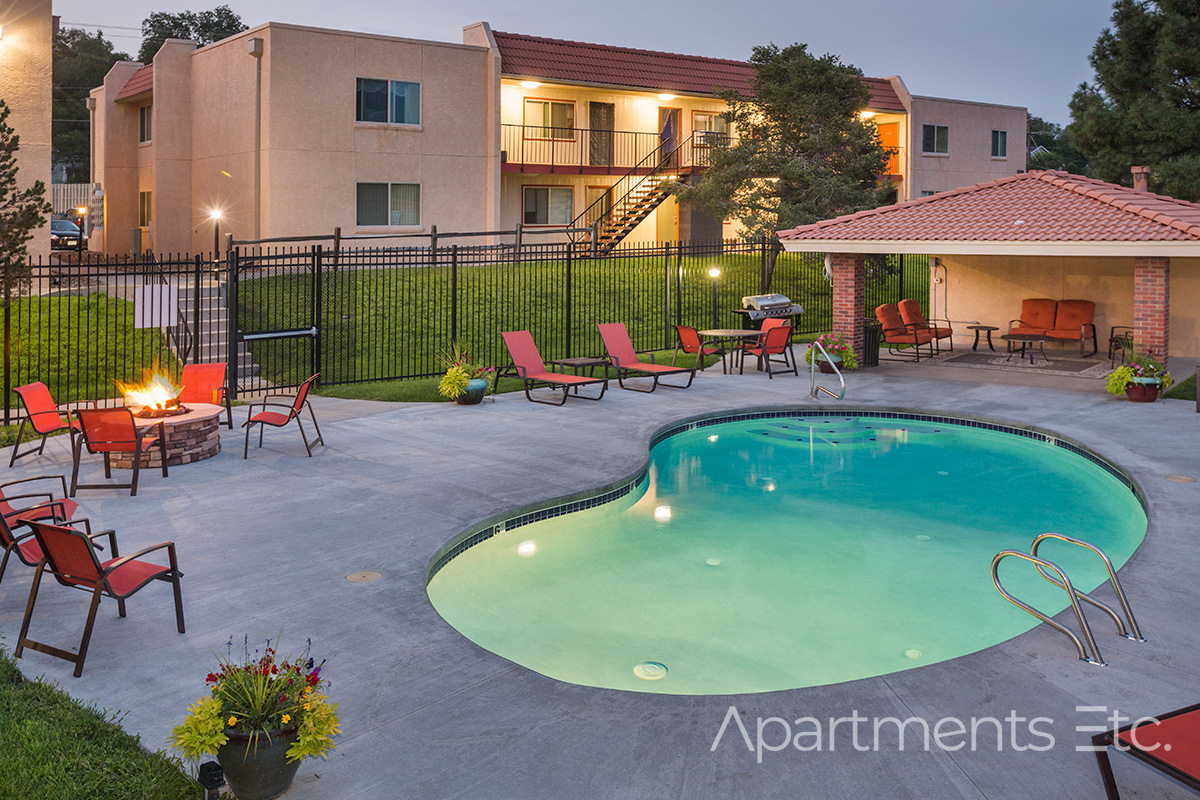 Apartment swimming pool and outdoor seating area at The Hills Apartments in Colorado Springs.